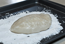 A lump of gyūhi dough on a floured pan